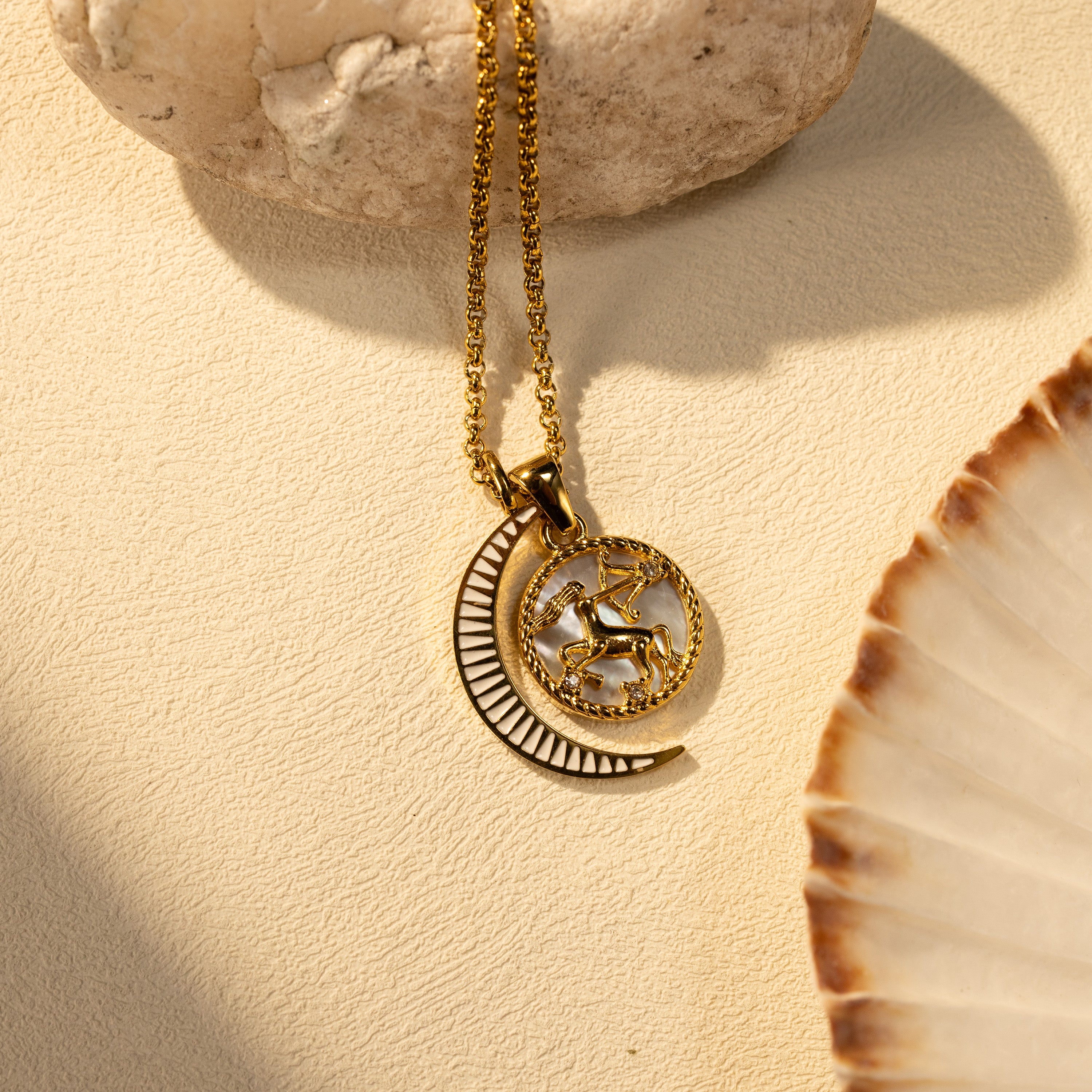 Silvbreeze Lunara Sagittarius zodiac mother-of-pearl moon necklace with a rolo chain displayed in a warm sunlight scene.