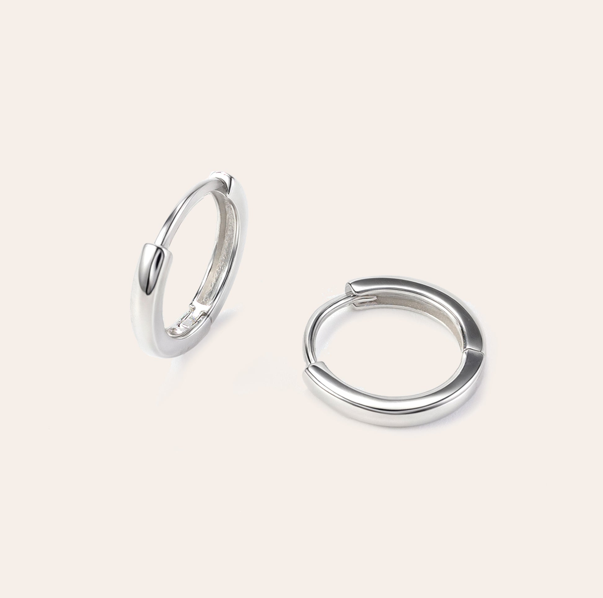 Lina white gold huggie earrings with a smooth minimalist finish, made in vermeil over sterling silver, lightweight and sweatproof by SILVBREEZE