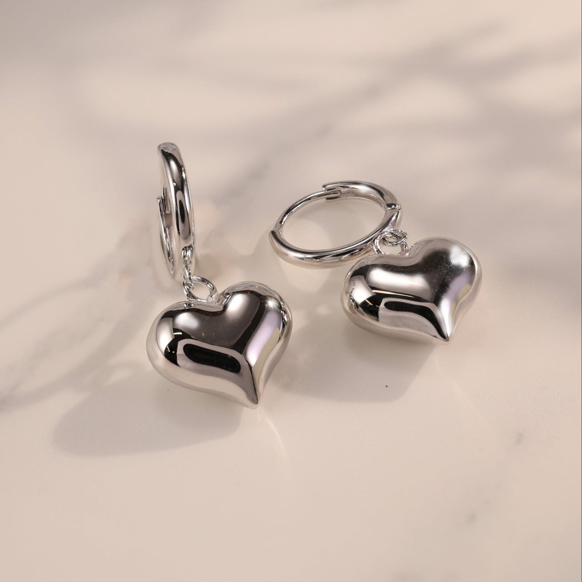 Lune white gold drop earrings with puffy heart charm and huggie hoop base, made in vermeil over sterling silver, lightweight and waterproof by SILVBREEZE