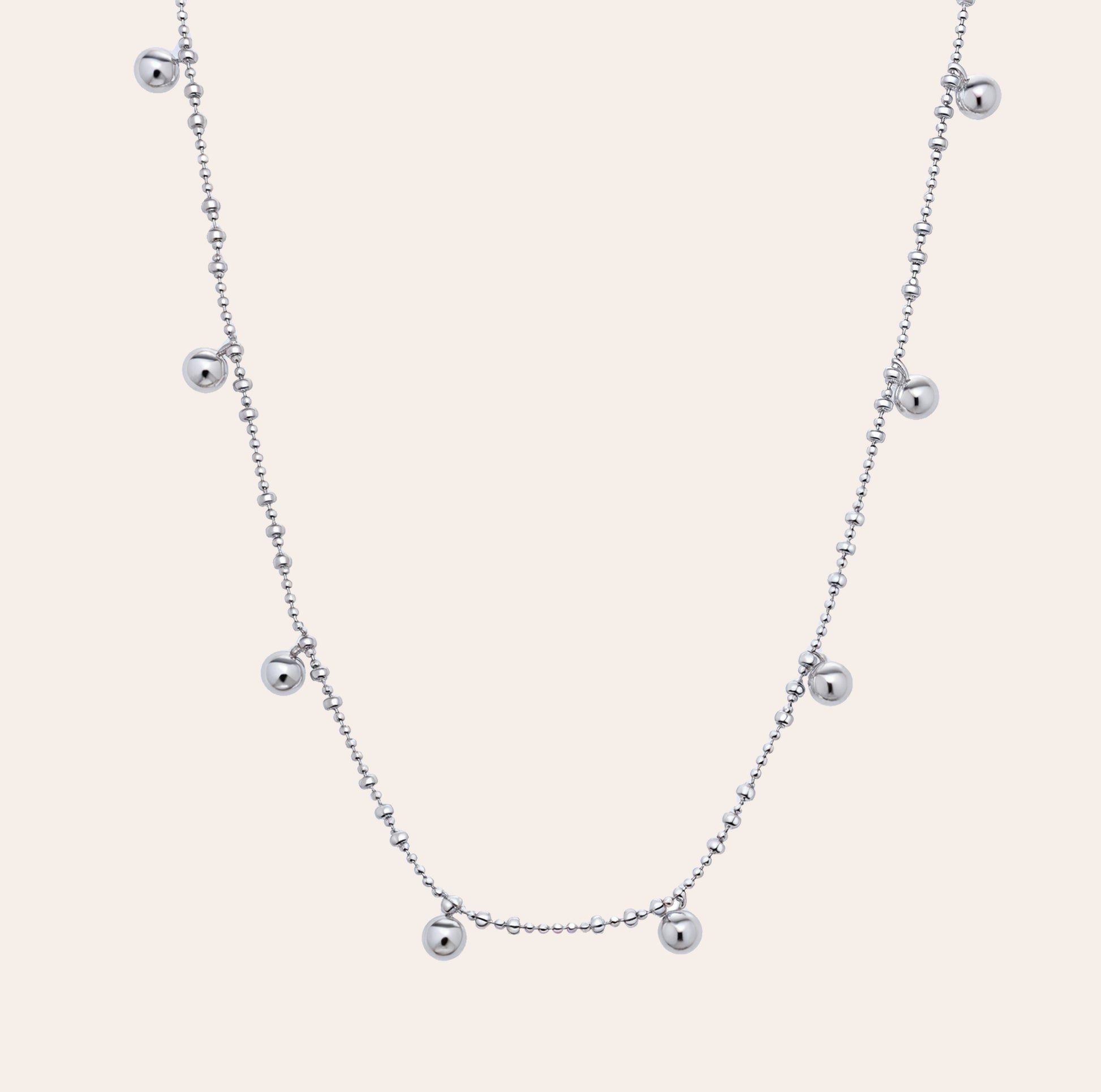 Lyric beaded necklace in white gold vermeil with floating silver beads on a dainty chain, crafted from sterling silver and perfect for athleisure layering by SILVBREEZE.