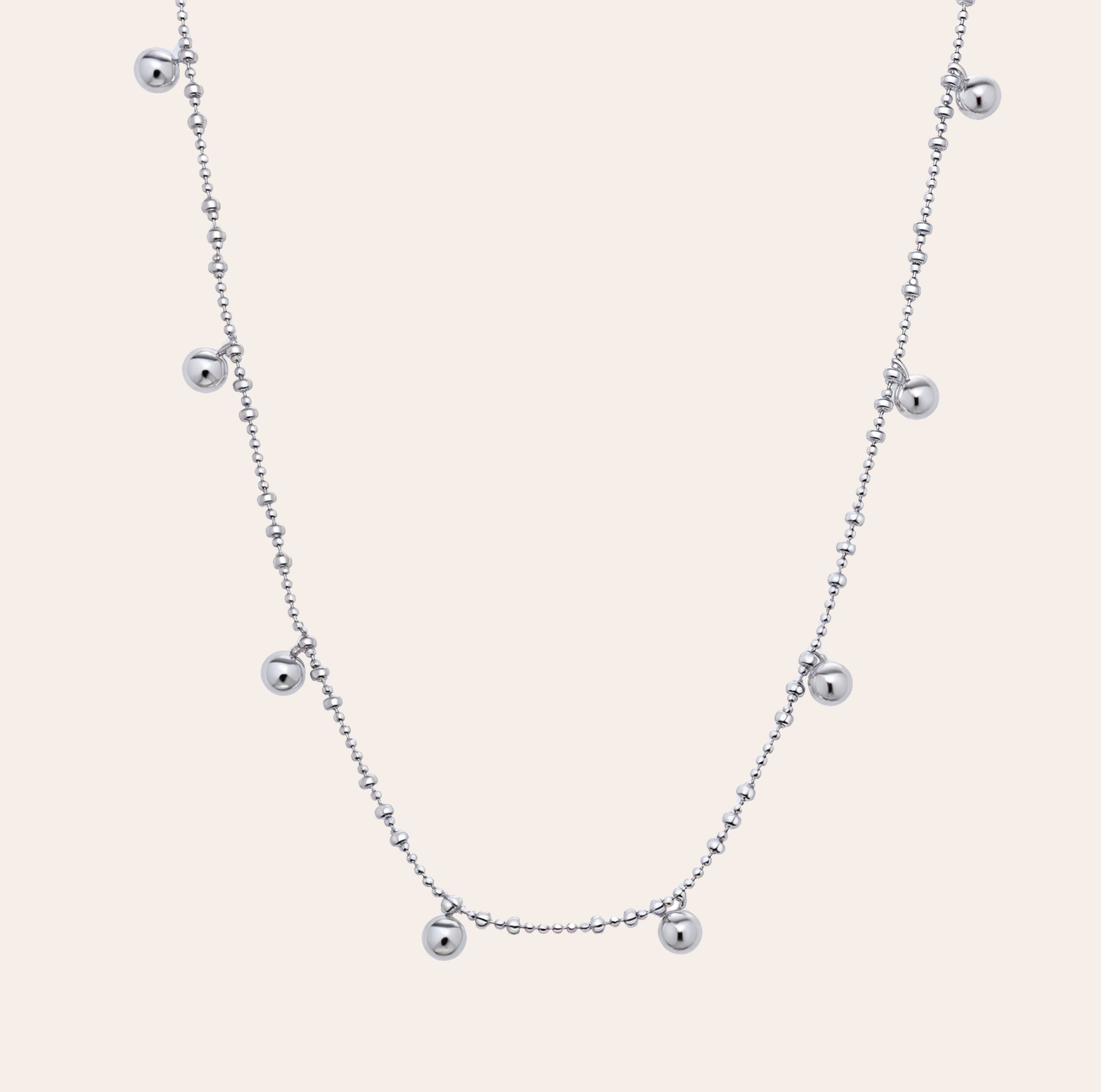 Lyric beaded necklace in white gold vermeil with floating silver beads on a dainty chain, crafted from sterling silver and perfect for athleisure layering by SILVBREEZE.