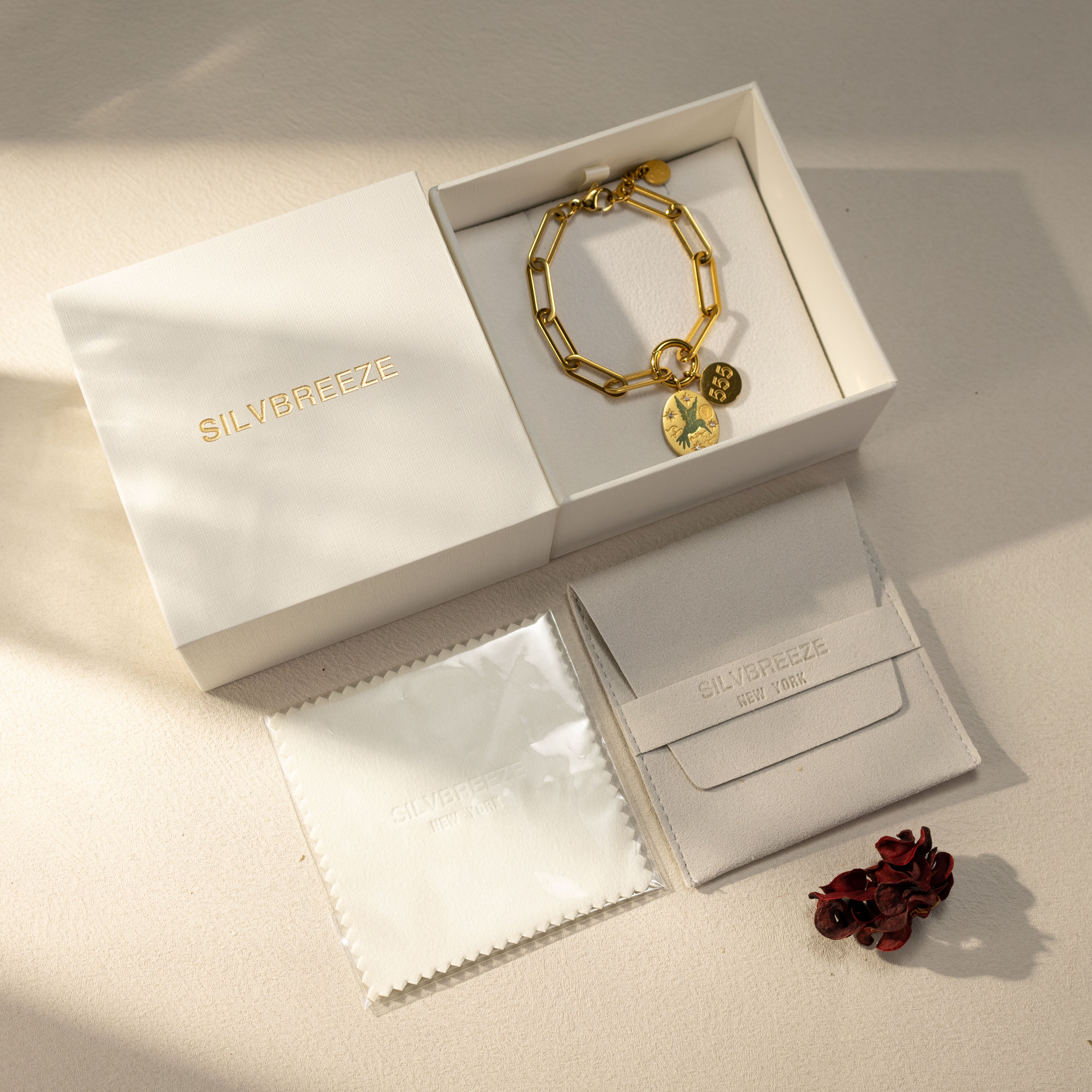 Silvbreeze Greenbird angel number 111 gold bracelet displayed in gift box with pouch and polishing cloth.