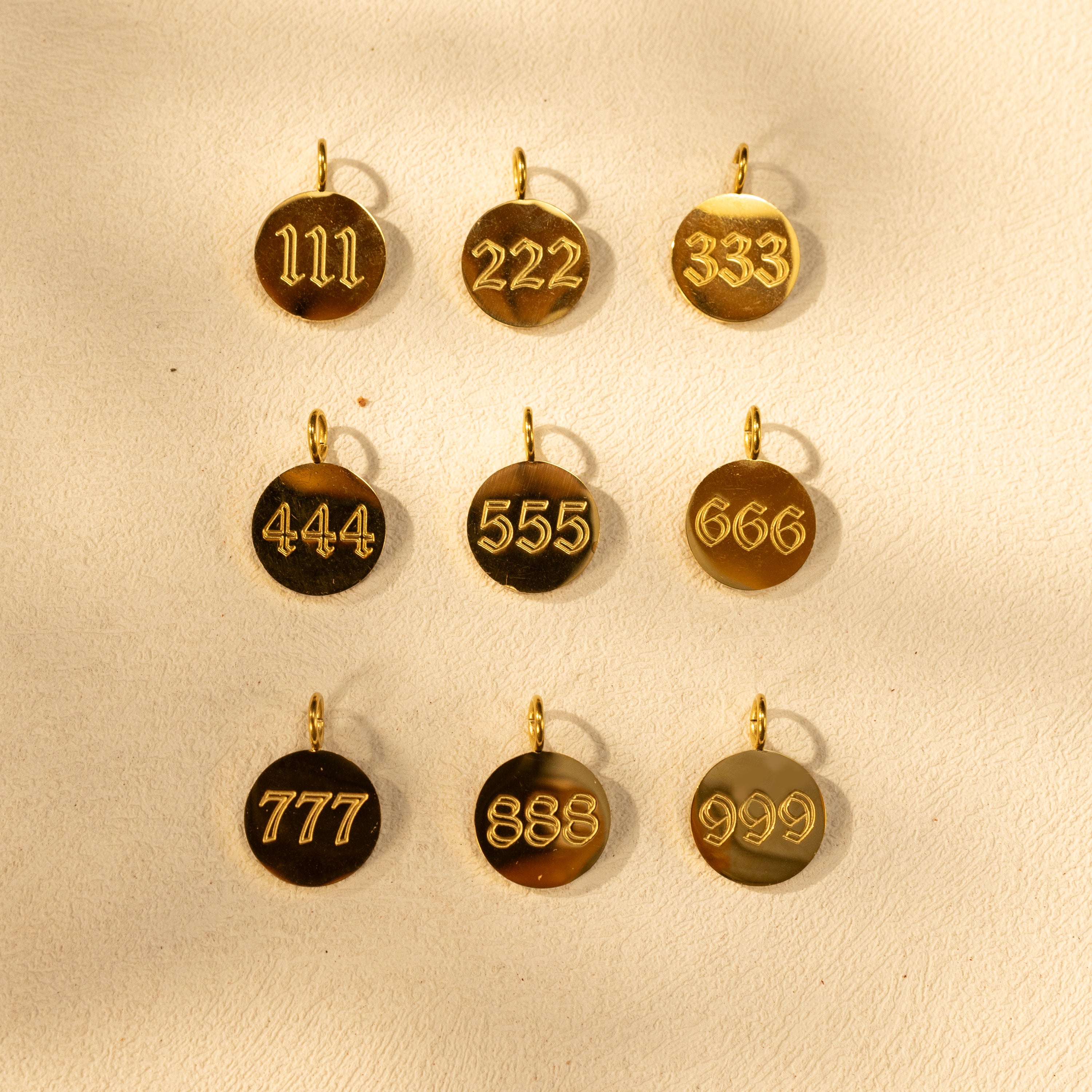 Selection of 18K gold-plated angel number charms (111–999), round disc pendants for customizing the paperclip O-clasp necklace.