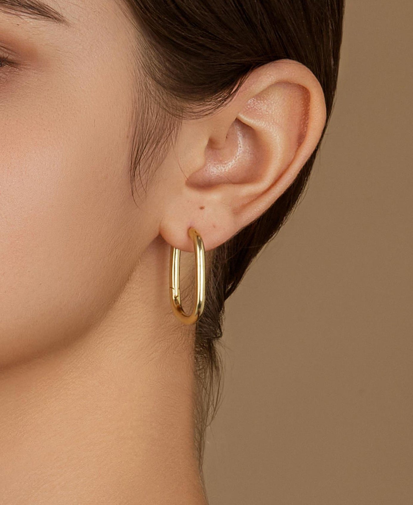 Close-Up of Athena Oval Hoop Earrings on Model – Polished 14K Gold, Hypoallergenic Jewelry
