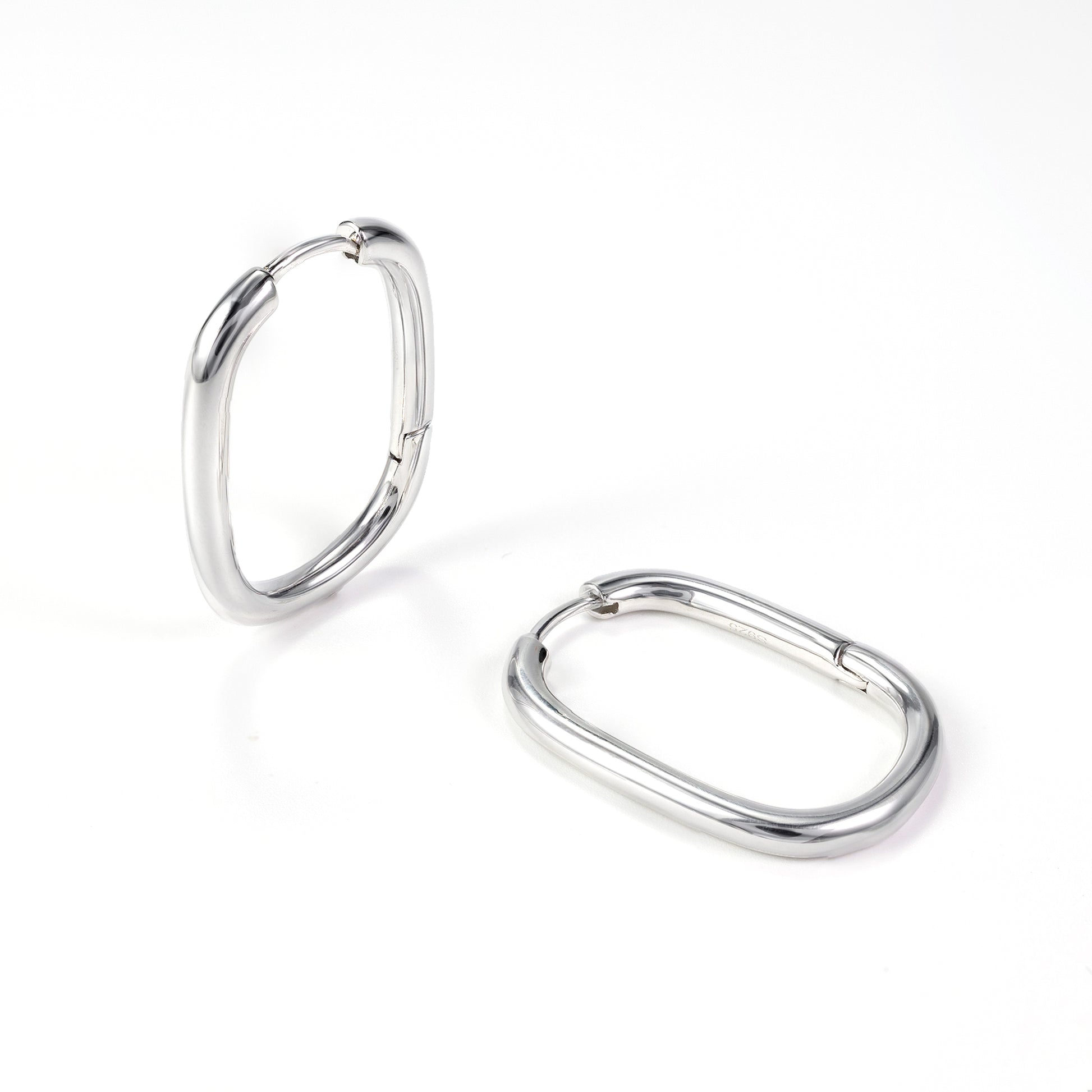 Silvbreeze Athena silver oval hoop earrings, sleek minimalist hinged hoops displayed on a clean white background