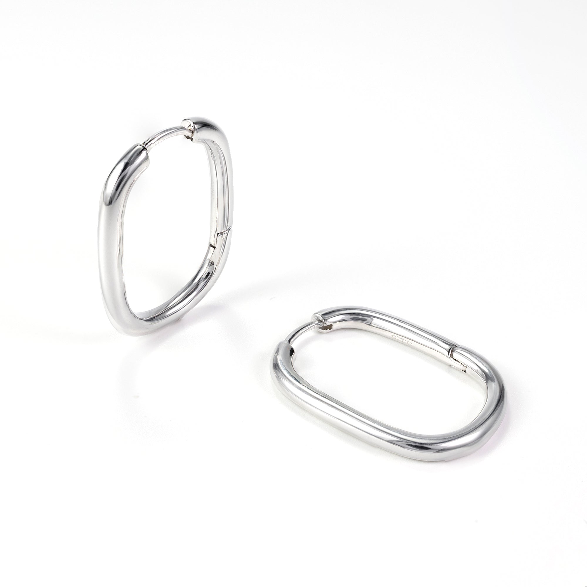 Silvbreeze Athena silver oval hoop earrings, sleek minimalist hinged hoops displayed on a clean white background