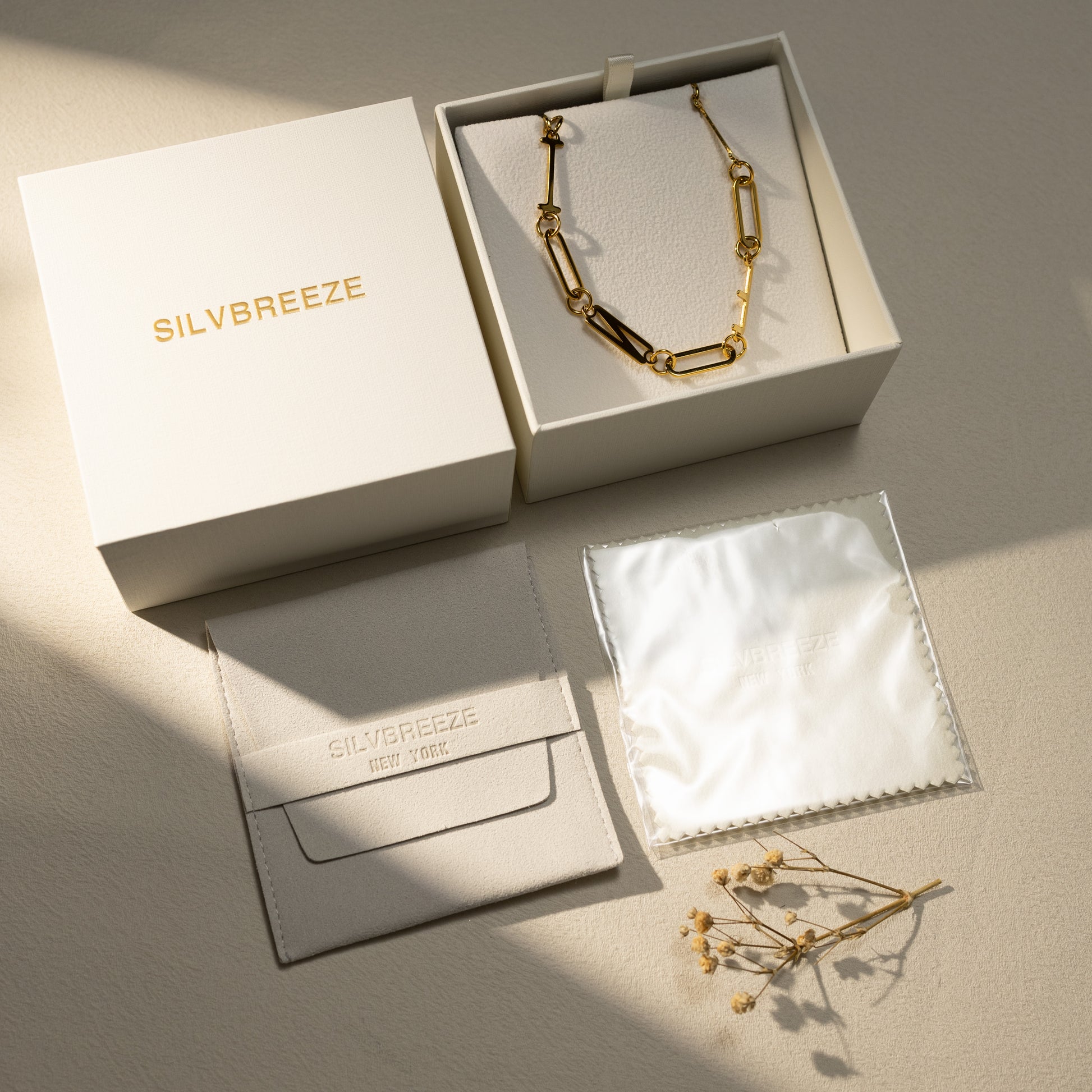 INFJ 18K gold paperclip chain necklace displayed in a Silvbreeze gift box with suede pouch and polishing cloth, styled in warm soft light — a gift-ready piece perfect for girlfriends, wives, and moms.