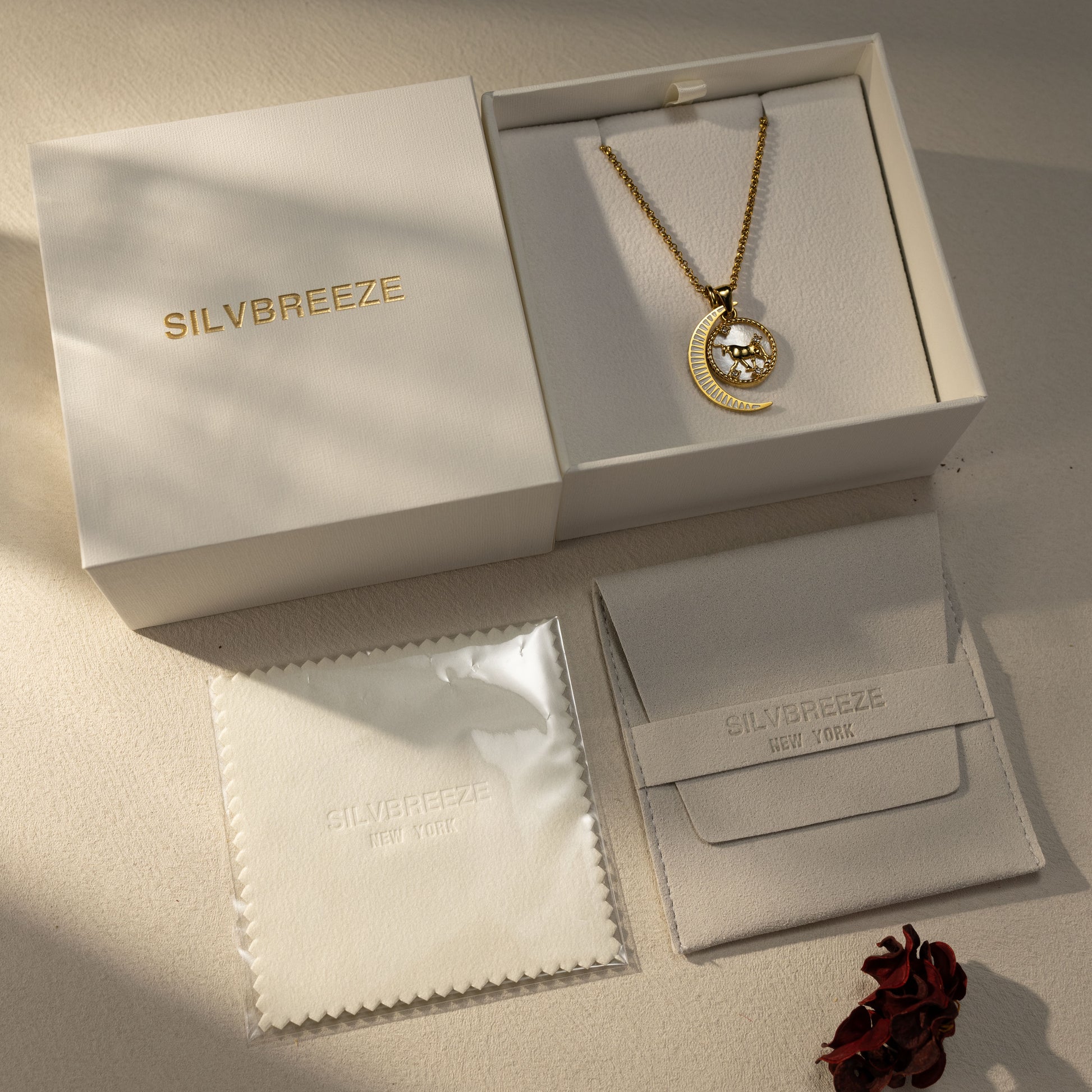 Silvbreeze Lunara Taurus zodiac necklace with rolo chain and moon mother-of-pearl pendant displayed in premium gift box.