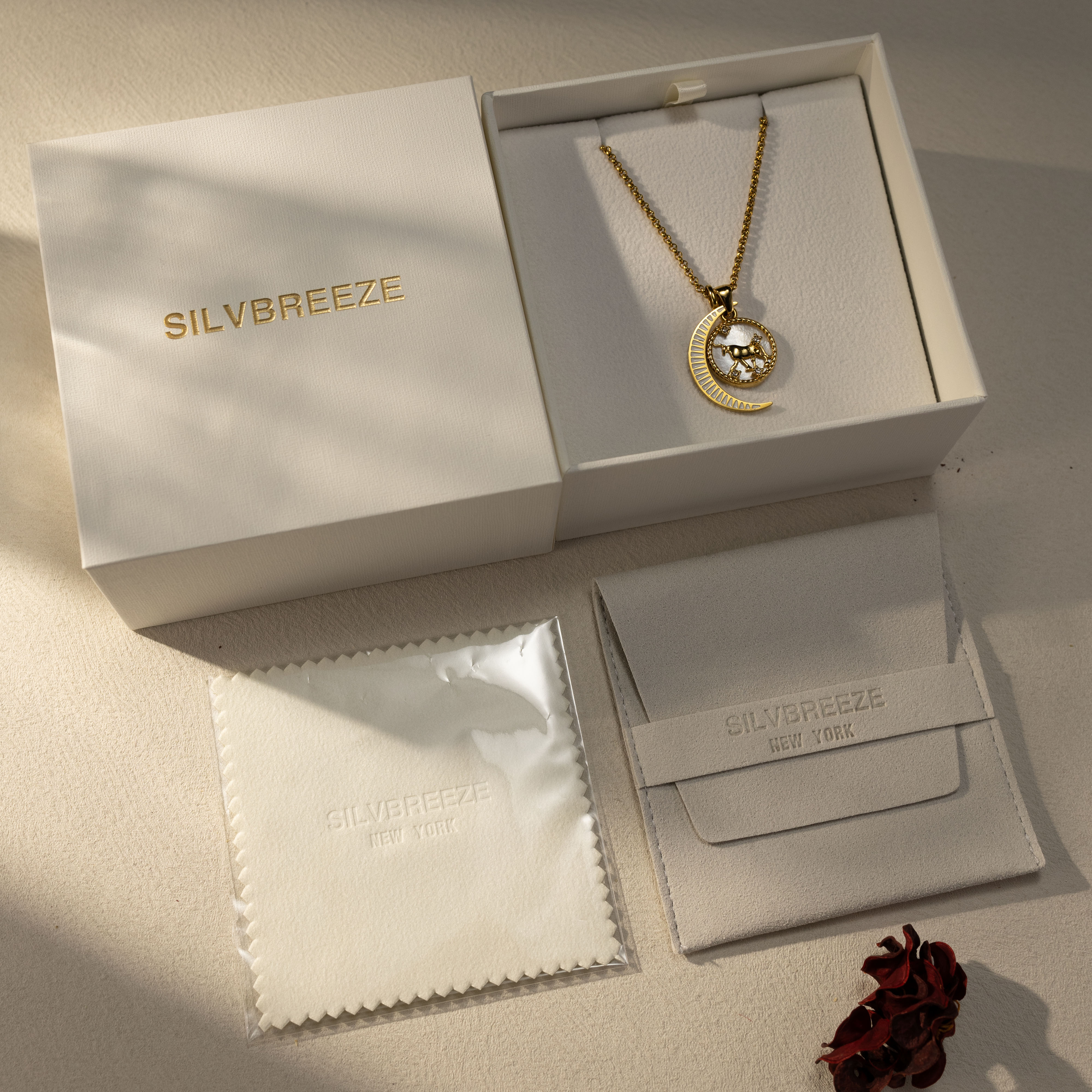 Silvbreeze Lunara Taurus zodiac necklace with rolo chain and moon mother-of-pearl pendant displayed in premium gift box.