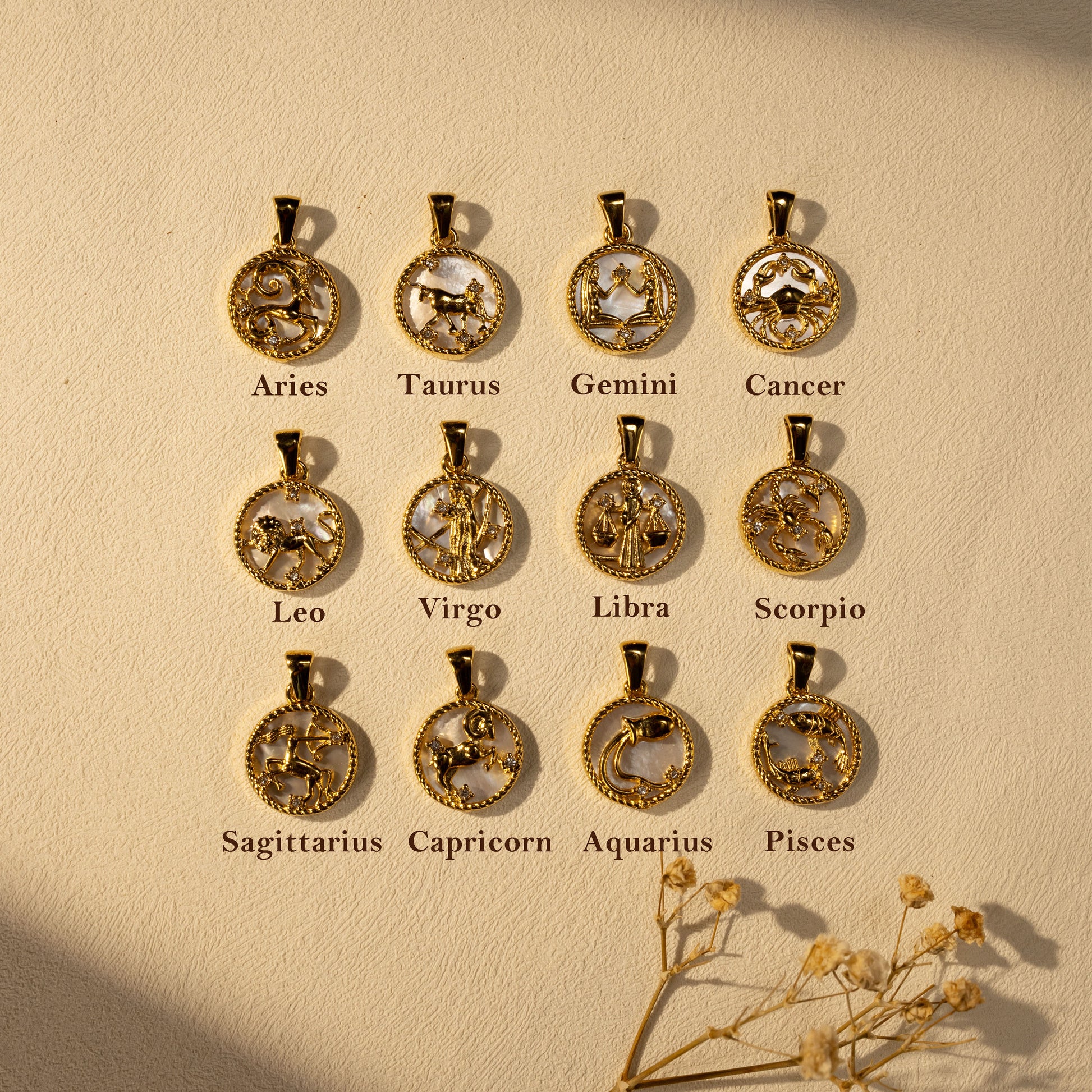 Silvbreeze Lunara Zodiac Collection showing all 12 gold mother-of-pearl zodiac pendants.