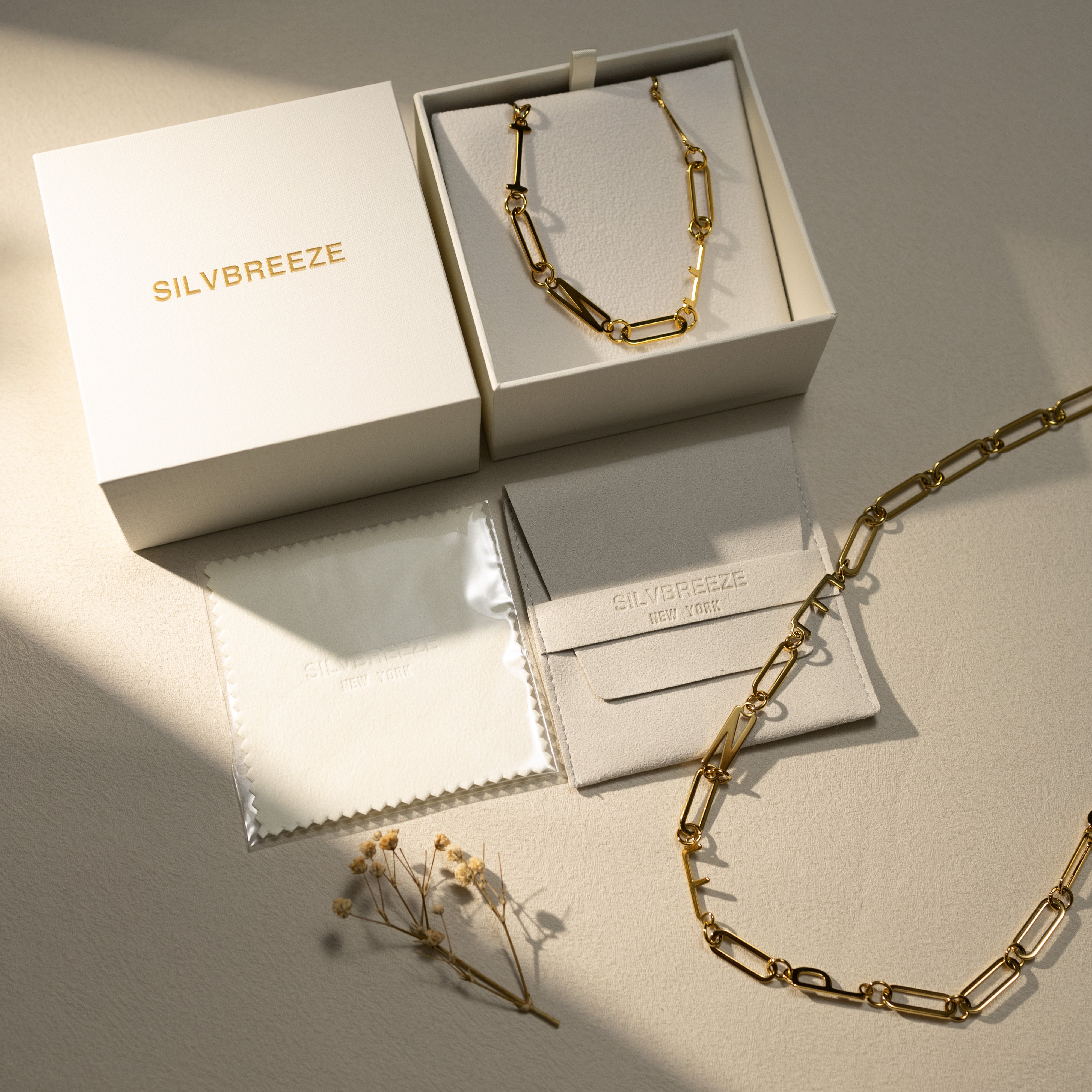 Silvbreeze MBTI 18K gold-plated personality necklaces displayed in a premium gift box set with jewelry pouch and polishing cloth under soft natural light.