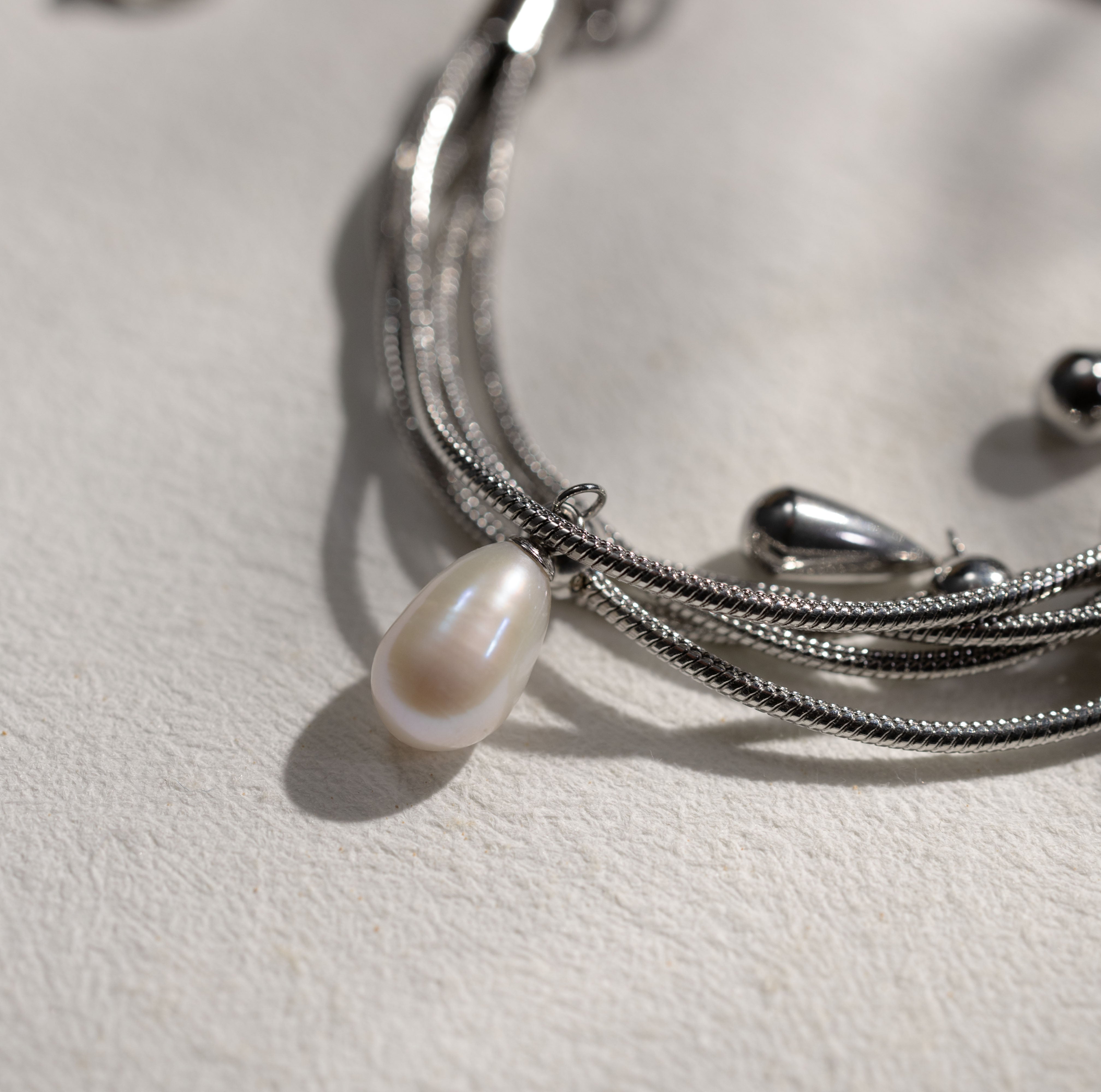 Detail view of Silvbreeze NORN pearl bracelet highlighting luminous mother of pearl pearls and polished steel beads