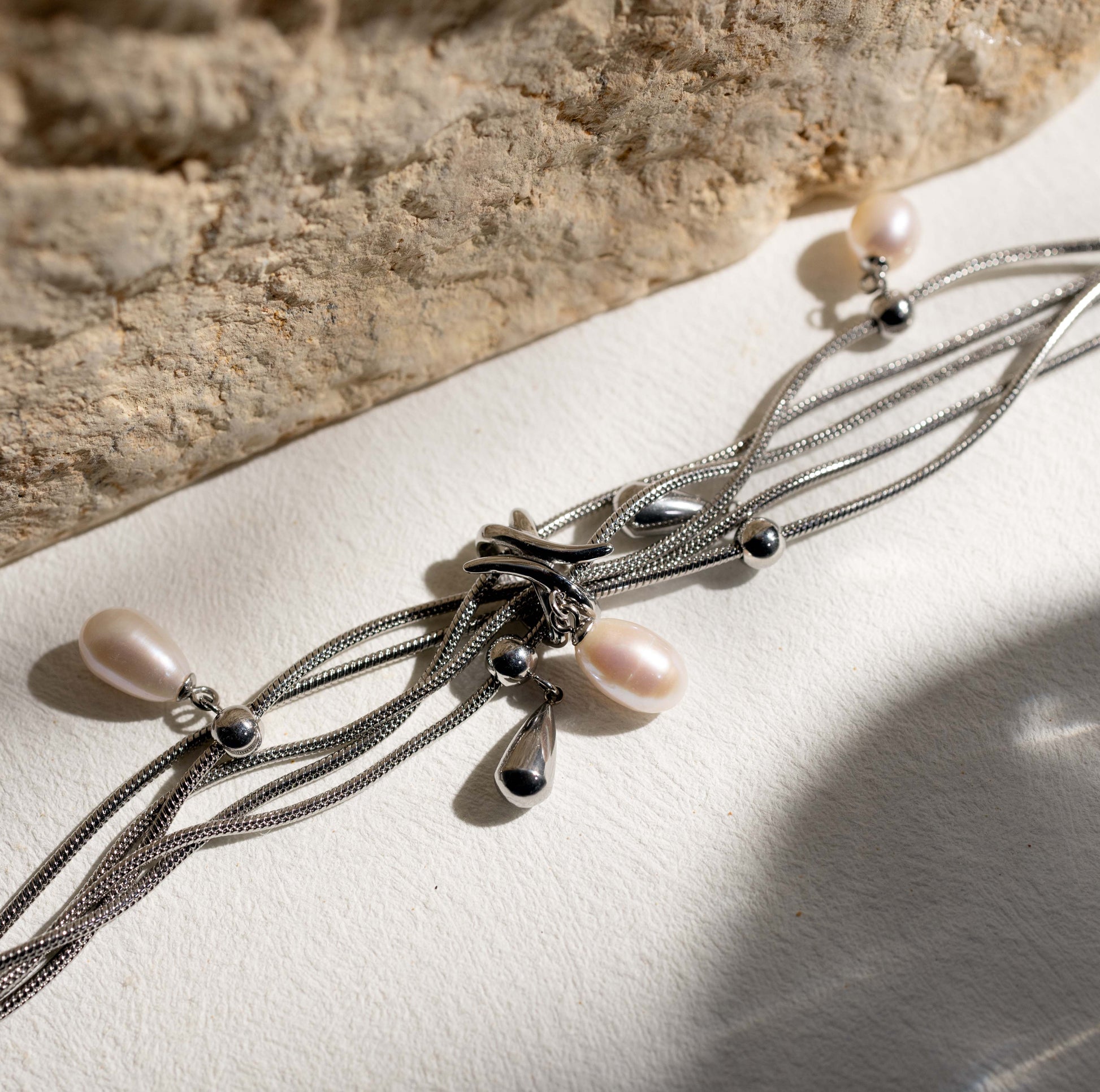 Silvbreeze NORN pearl bracelet with flowing snake chains and mother of pearl beads photographed in soft natural light