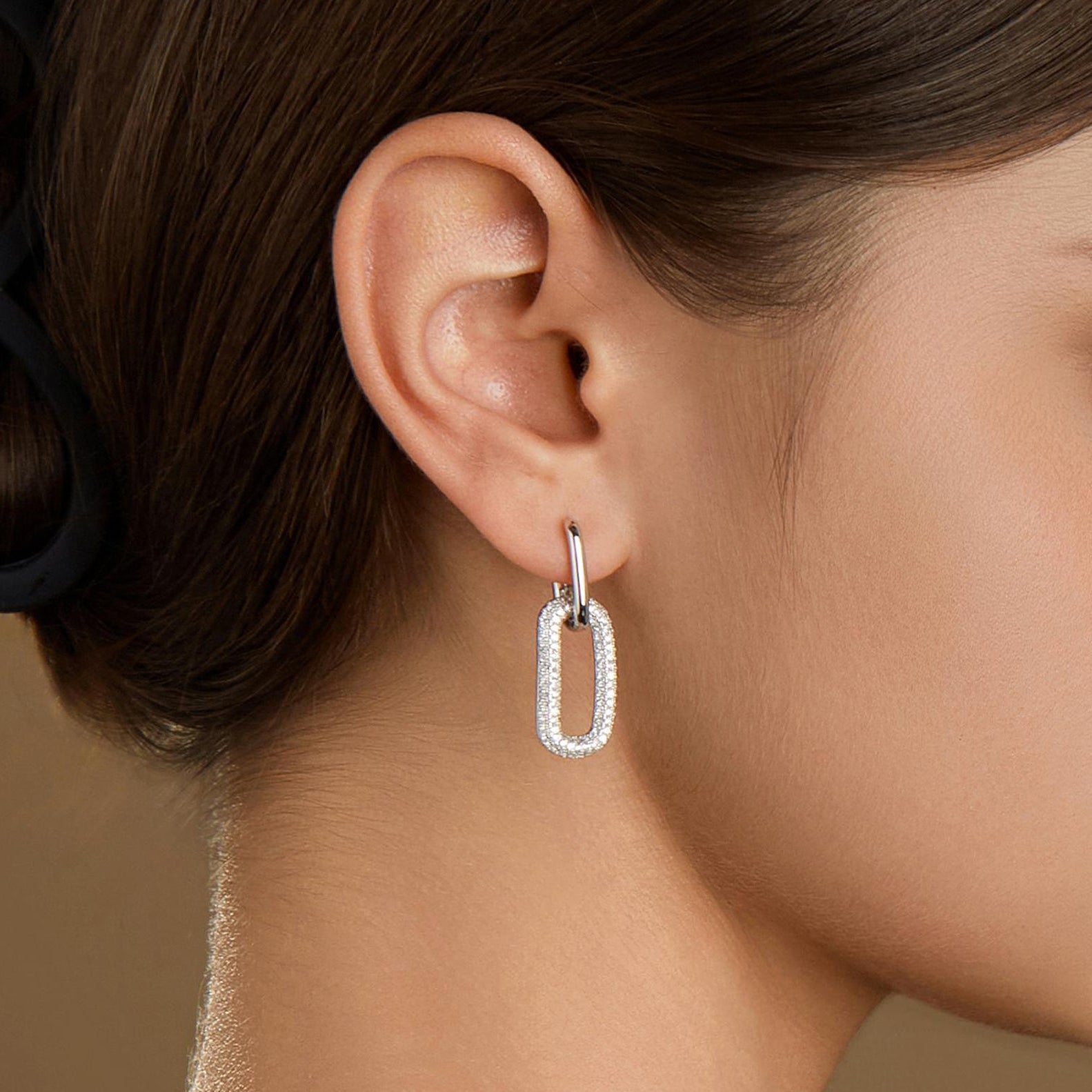 Model wearing the Silvbreeze Ona Paperclip Drop Earrings in silver, close-up view showing the sparkling pavé rectangle link design.