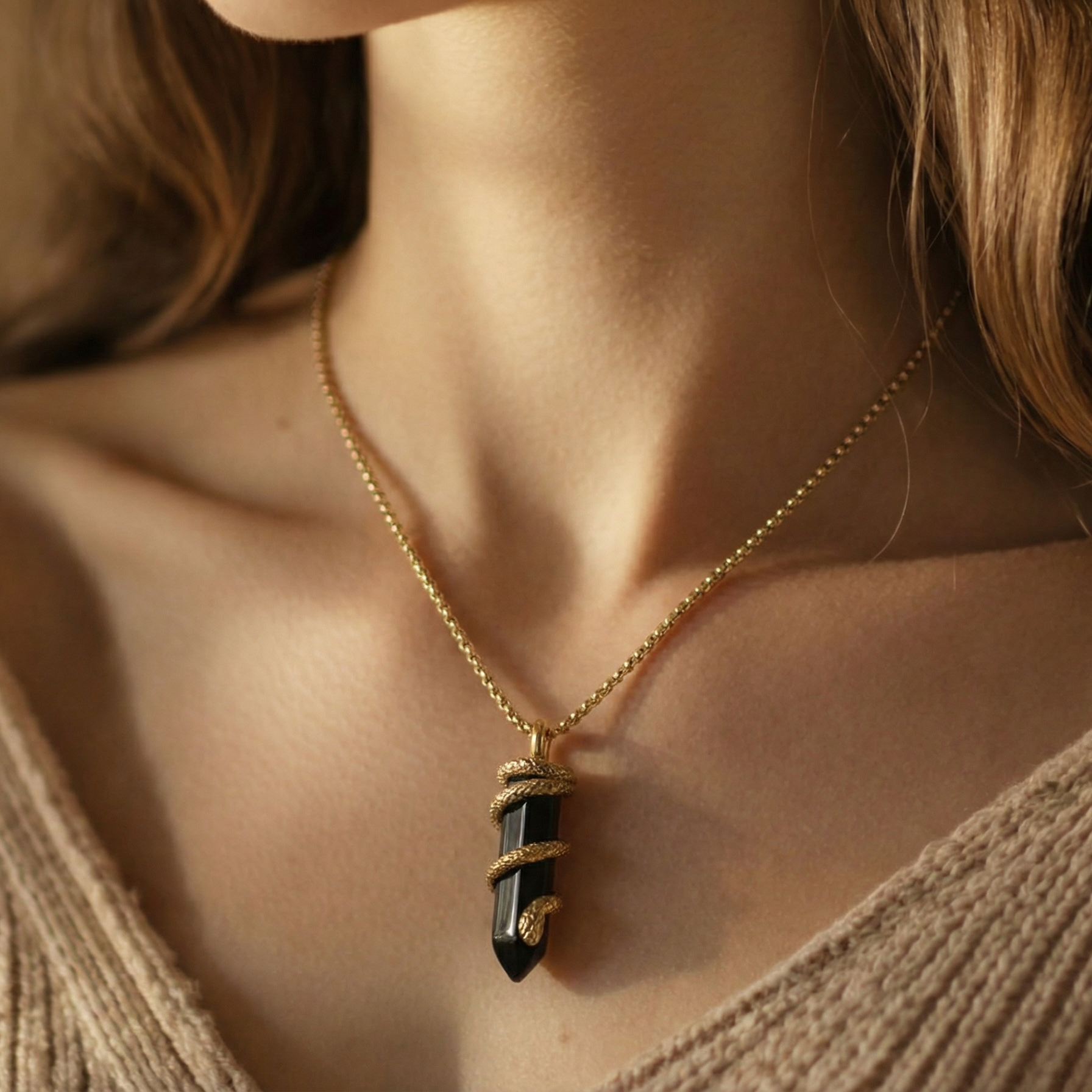 Silvbreeze Ouroboros serpent obsidian necklace worn on the neckline, symbolizing protection and inner stability