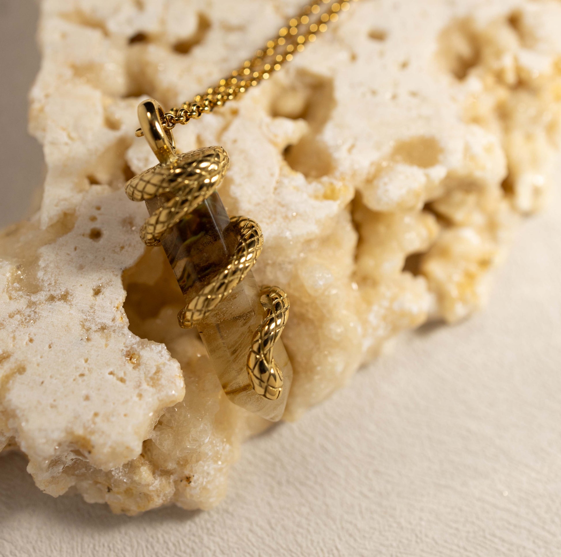 Close-up of Silvbreeze Ouroboros serpent necklace featuring refined tiger’s eye gemstone with detailed gold serpent texture